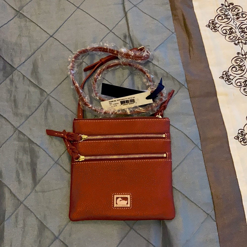 Dooney & Bourke north/south triple zip red leather.